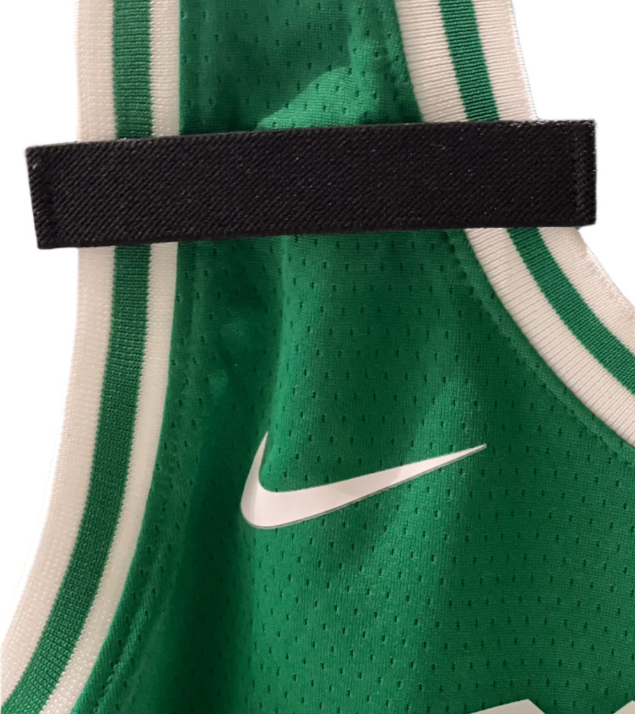 Badgeart mourning band for basketball jersey. Attaches with hook & loop. shown on a Boston Celtics basketball jersey.