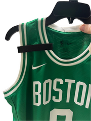 Badgeart mourning band for basketball jersey. Attaches with hook & loop. shown on a Boston Celtics basketball jersey. Tribute honor respect for fallen player, coach and others.