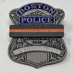 The Stop Gun Violence Wear Orange Awareness / Thin Orange Line Mourning Bars for Cloth Badges and insignia.  Black vinyl with a thin orange line mourning bar with a pair of 1/2" pins with military clasps.  Public safety officers are wearing thin orange line badge shrouds to raise awareness of gun violence in the community and among police officers, firefighters, Emergency Medical Services and others.  J