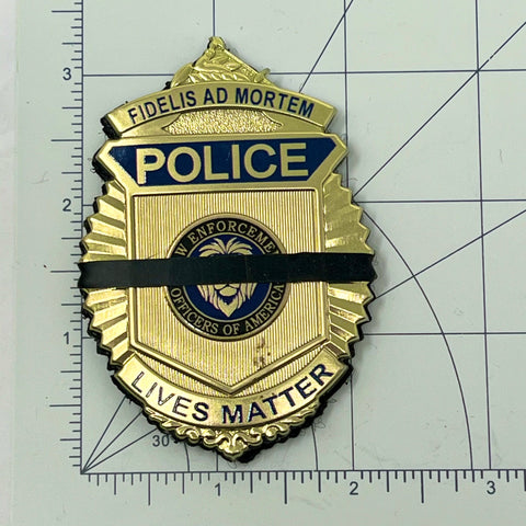New Product Black silicone mourning band 0.2 inches wide fits badges 1.2 to 2.25 inches offered by badgeart. Band Shown on a police lives matter police badge on graph demonstrating size